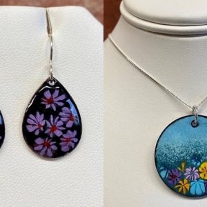 rain drop shape purple enamel earrings on white background with flowerdesign and round blue pendant wiht flower design on white background